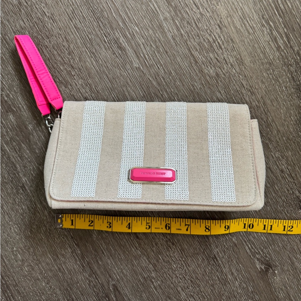 Victoria’s Secret clutch bag beige with hot pink details and white sequins.